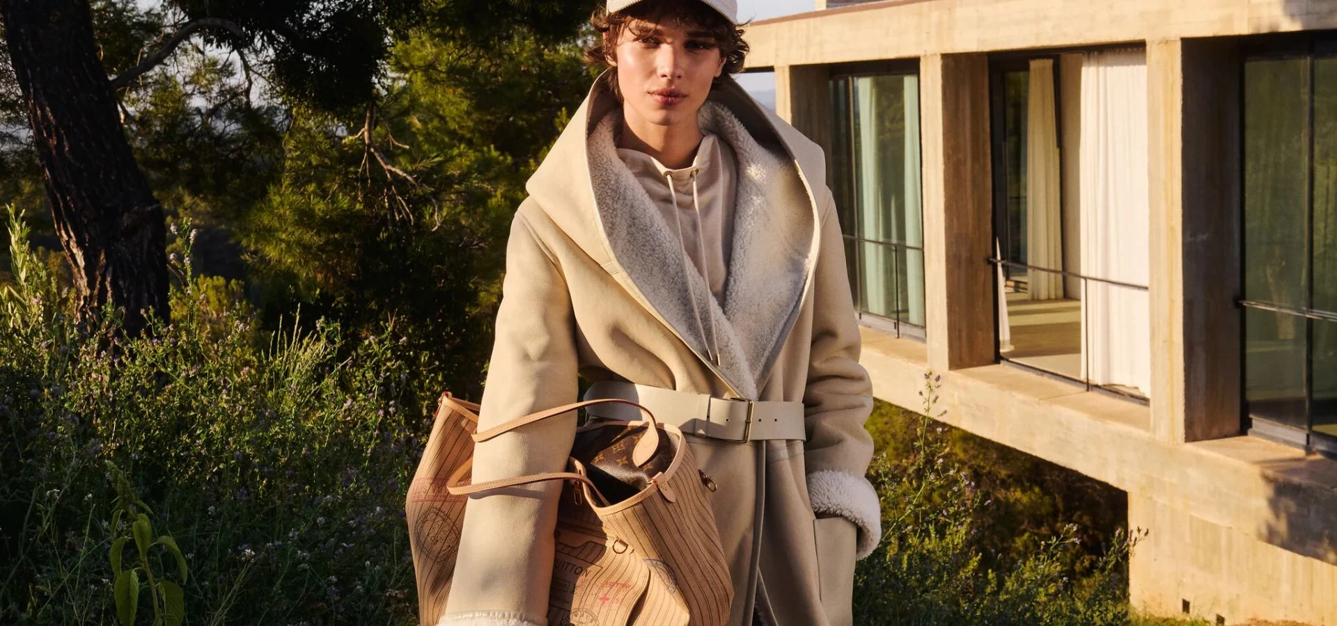 Woman in a beige coat carrying a handbag